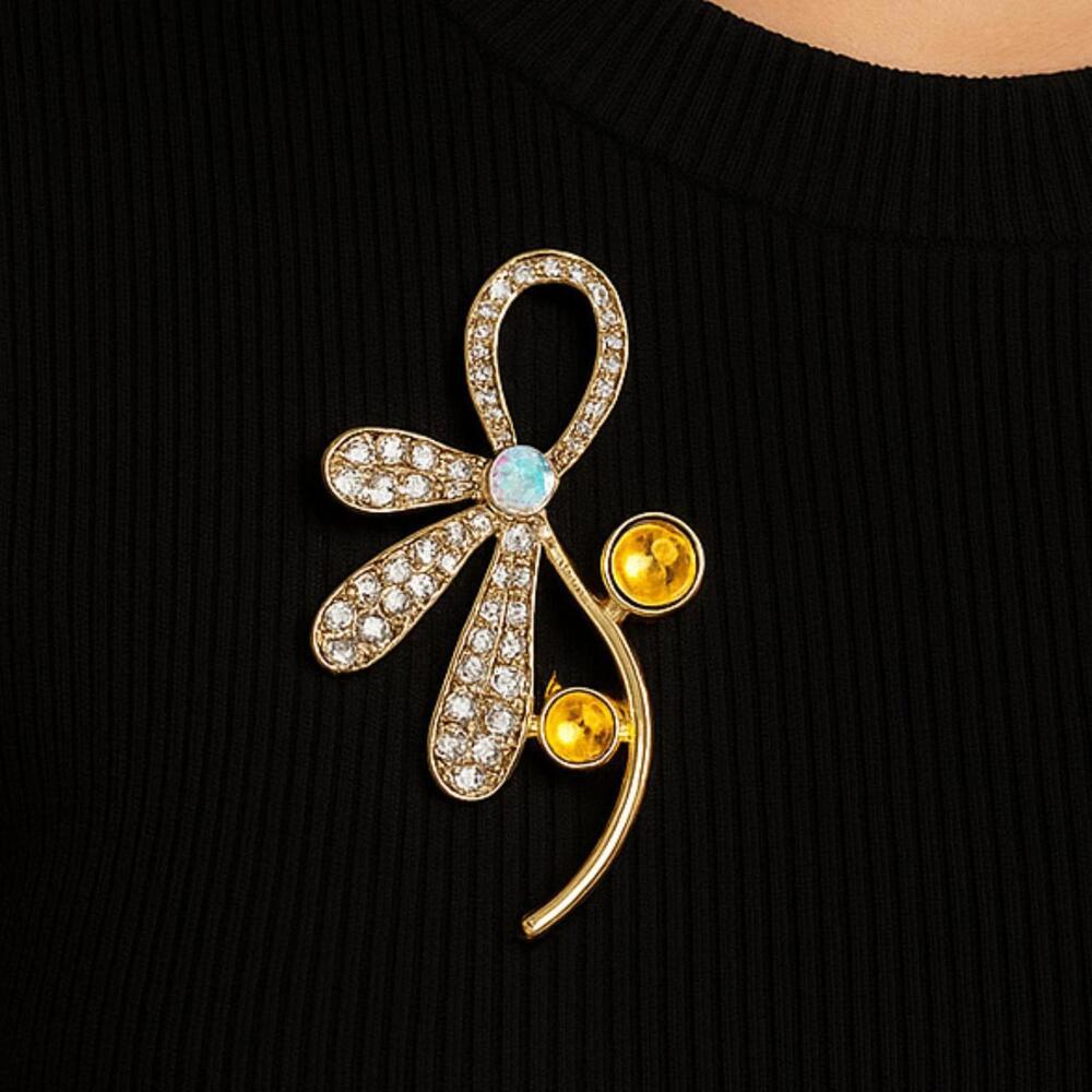 Brand New gold-tone floral brooch with silver details and safety pin closure.